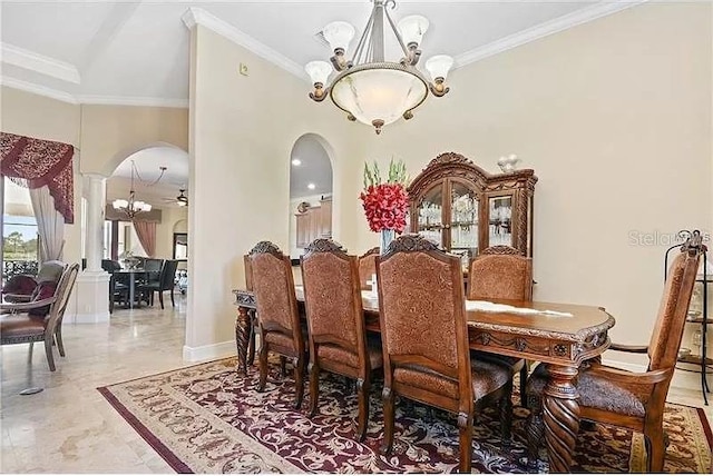 dining space with ceiling fan with notable chandelier and ornamental molding