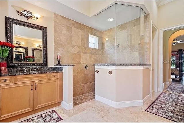 bathroom with vanity and a tile shower