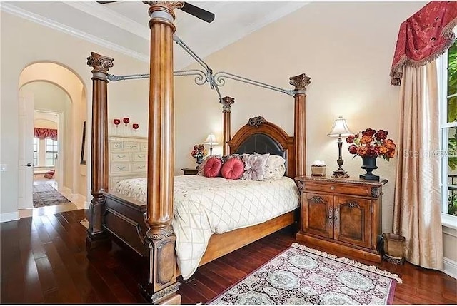 bedroom featuring ceiling fan, dark wood-type flooring, crown molding, and multiple windows