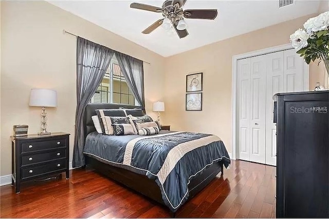 bedroom with ceiling fan, a closet, and dark wood-type flooring