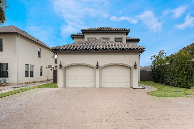 mediterranean / spanish-style home with a garage