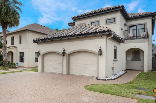 mediterranean / spanish-style house featuring a balcony and a garage