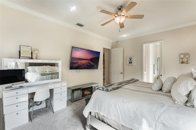 bedroom with ceiling fan, carpet floors, and ornamental molding