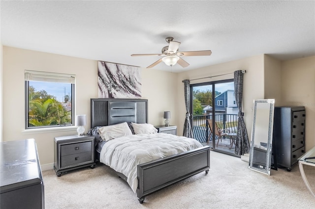 carpeted bedroom with ceiling fan and access to outside