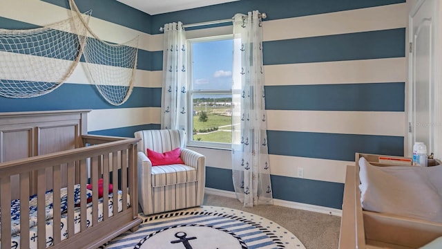 bedroom featuring light carpet, a nursery area, and multiple windows