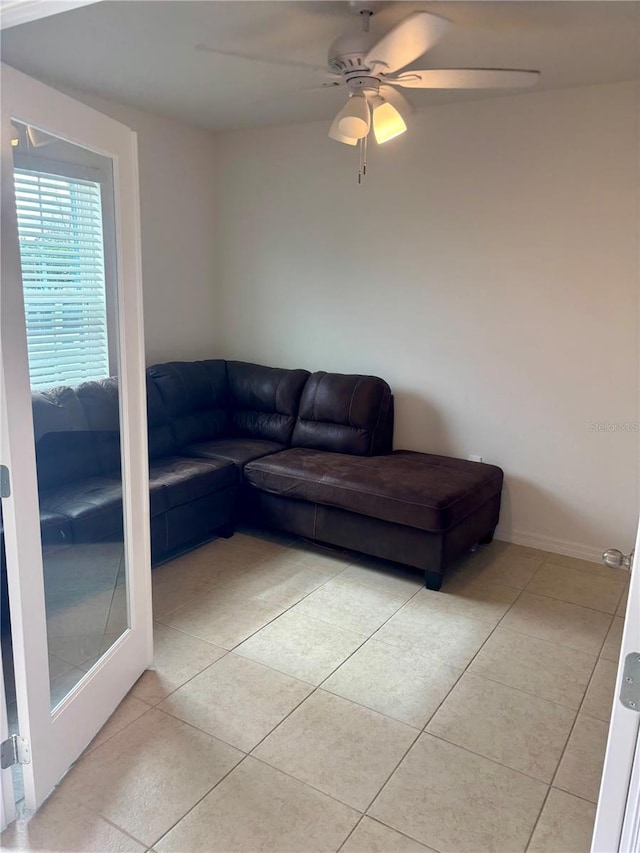 tiled living room featuring ceiling fan