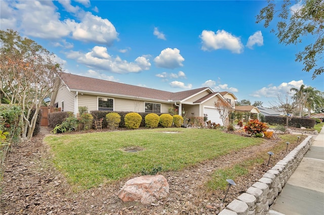 ranch-style home with a garage and a front yard