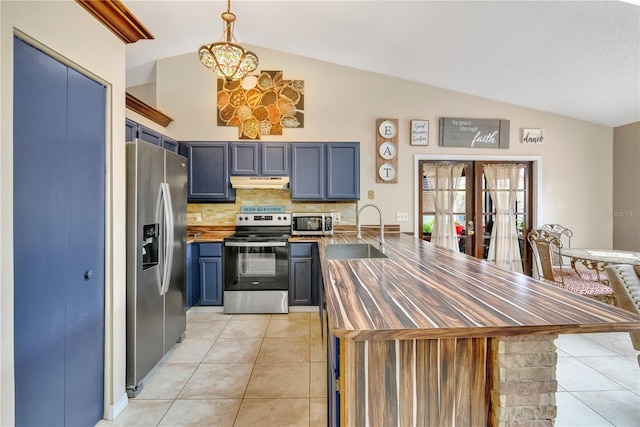 kitchen featuring sink, appliances with stainless steel finishes, and vaulted ceiling