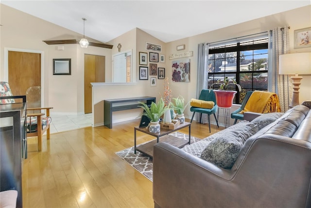 living room with vaulted ceiling and light hardwood / wood-style floors