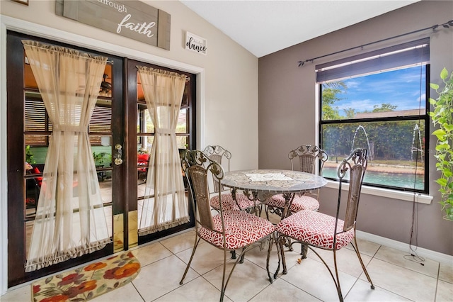 tiled dining area with lofted ceiling