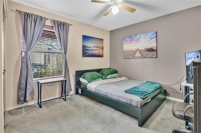 bedroom featuring ceiling fan and light carpet