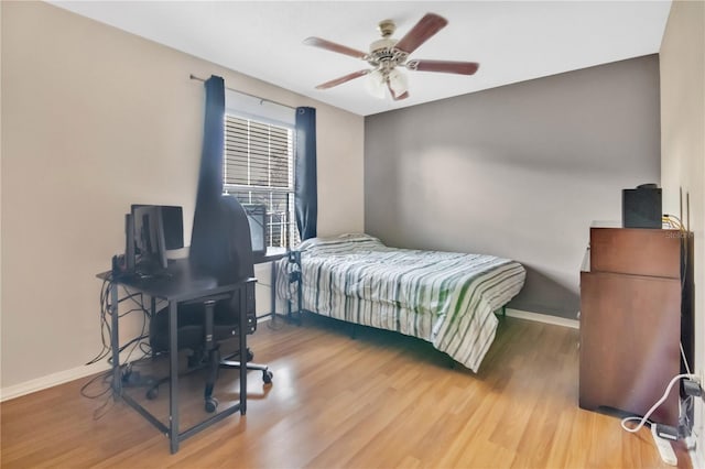 bedroom with ceiling fan and hardwood / wood-style flooring