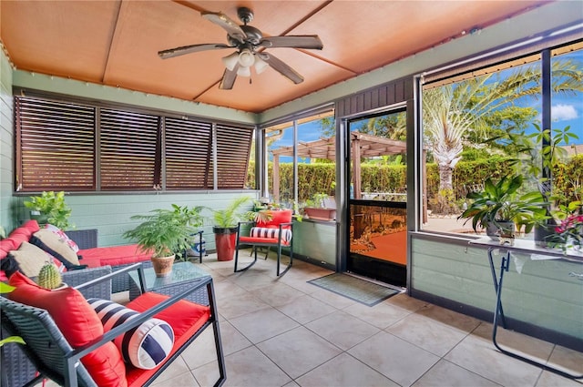 sunroom / solarium featuring ceiling fan