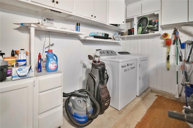 laundry room with independent washer and dryer and cabinets