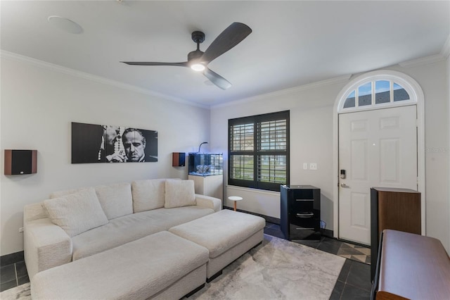 living room with ceiling fan, dark tile patterned floors, and crown molding