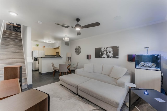 living room featuring ceiling fan and crown molding