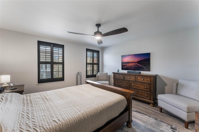 bedroom with ceiling fan and wood-type flooring