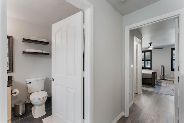 bathroom with ceiling fan, toilet, and hardwood / wood-style flooring