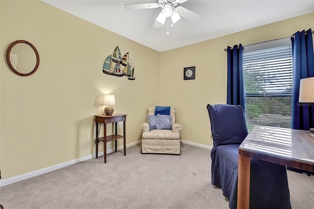 carpeted office space with ceiling fan