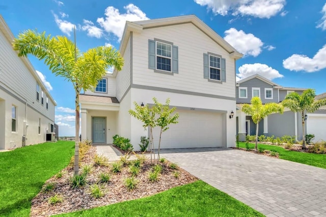 view of front of house with a garage and a front lawn