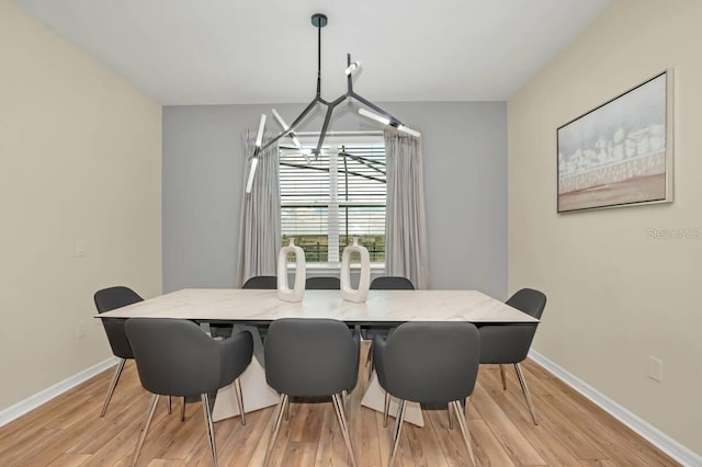 dining room featuring light hardwood / wood-style flooring and a chandelier