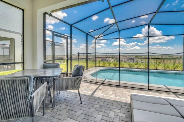 view of swimming pool with a lanai and a patio area