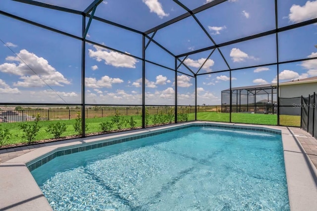 view of swimming pool featuring a lanai and a lawn