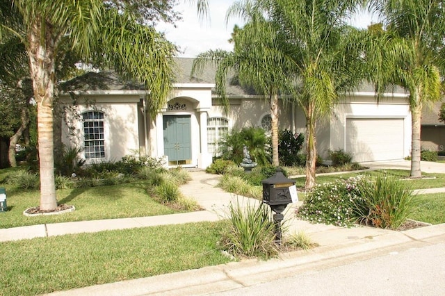 view of front facade featuring a garage and a front yard