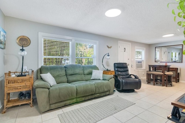 tiled living room with cooling unit and a textured ceiling