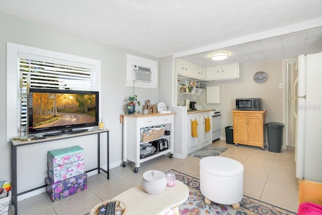 living room featuring light tile patterned floors and a wall unit AC