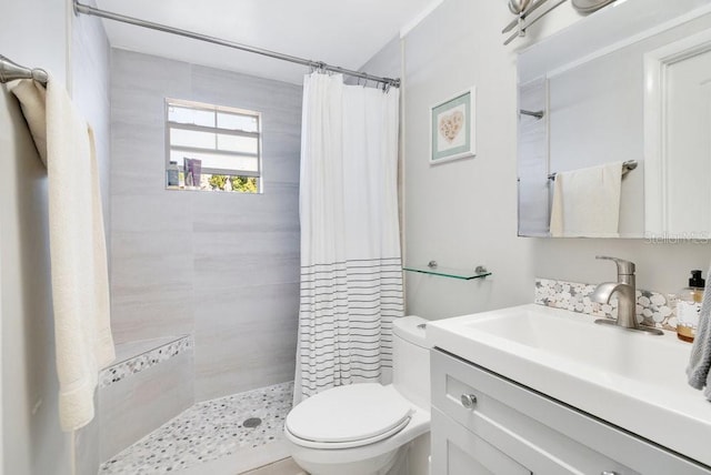 bathroom with walk in shower, vanity, and toilet