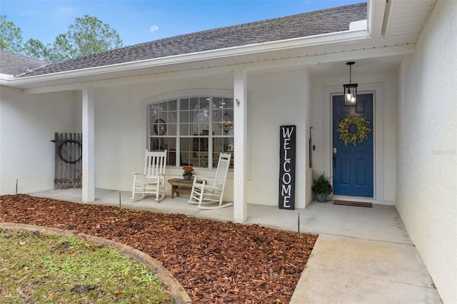 view of exterior entry with covered porch