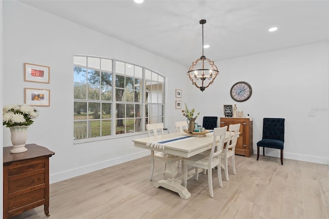 dining area featuring a healthy amount of sunlight, a chandelier, and light hardwood / wood-style floors