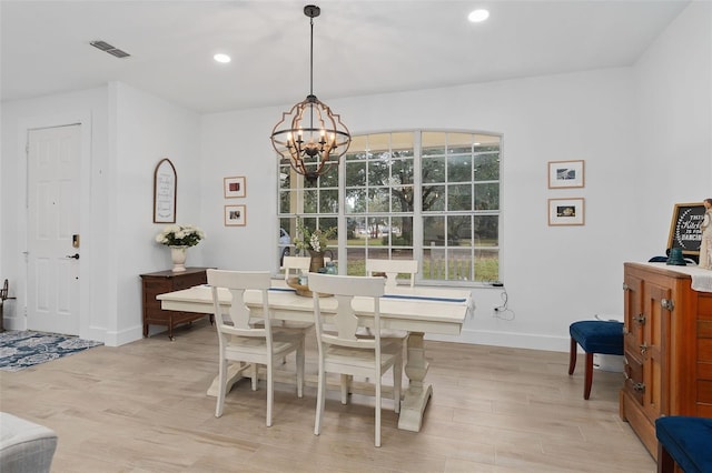 dining room with a chandelier and light hardwood / wood-style flooring