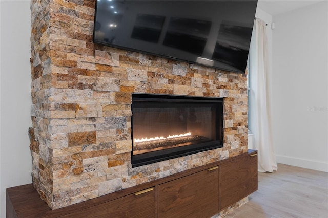 interior details with hardwood / wood-style flooring and a fireplace