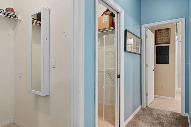 corridor featuring light colored carpet