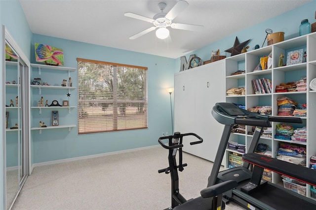 exercise area featuring light colored carpet and ceiling fan