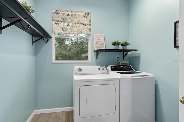 washroom with wood-type flooring and independent washer and dryer