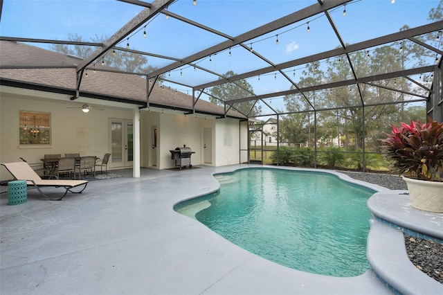 view of swimming pool featuring a patio, area for grilling, ceiling fan, and glass enclosure