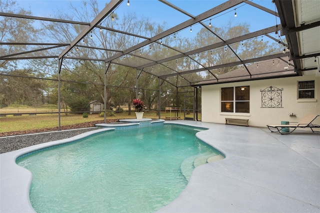 view of pool with a patio area, an in ground hot tub, and glass enclosure