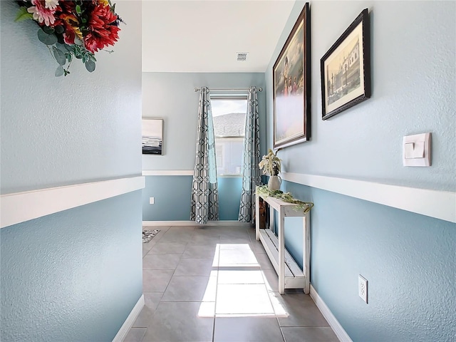 hall featuring light tile patterned flooring