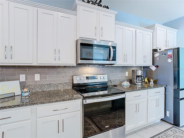 kitchen with white cabinets, backsplash, and appliances with stainless steel finishes