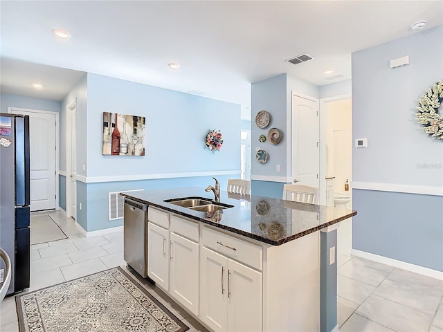 kitchen featuring white cabinets, stainless steel appliances, sink, a kitchen island with sink, and light tile patterned flooring