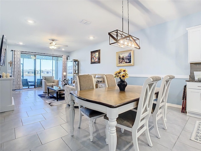 tiled dining space featuring ceiling fan