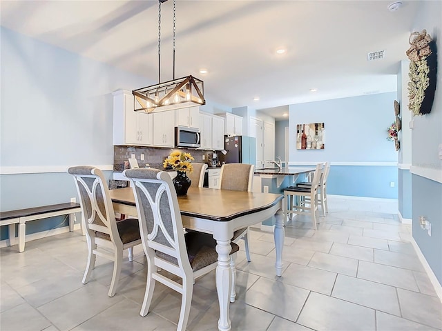 tiled dining space featuring sink