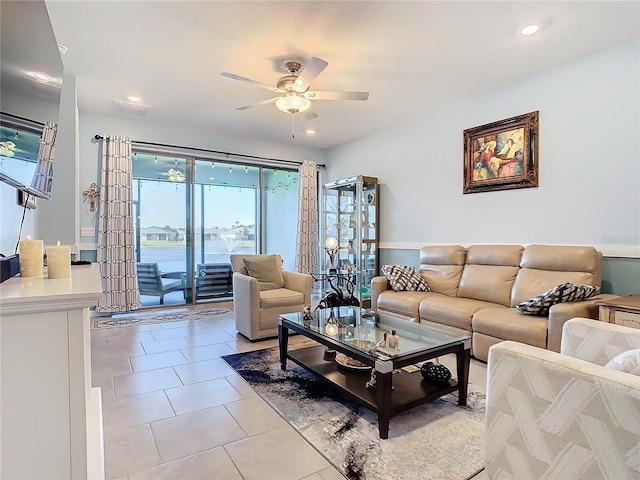 living room featuring ceiling fan and light tile patterned flooring