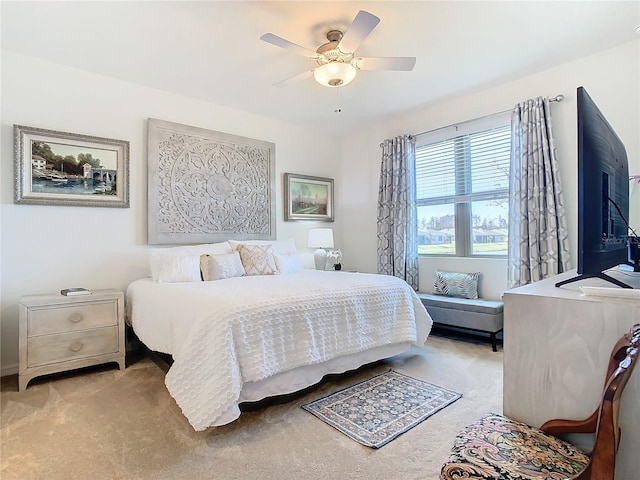 bedroom with ceiling fan and light carpet