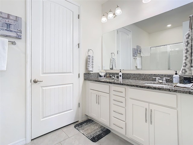 bathroom with tile patterned floors, vanity, and a shower with shower door