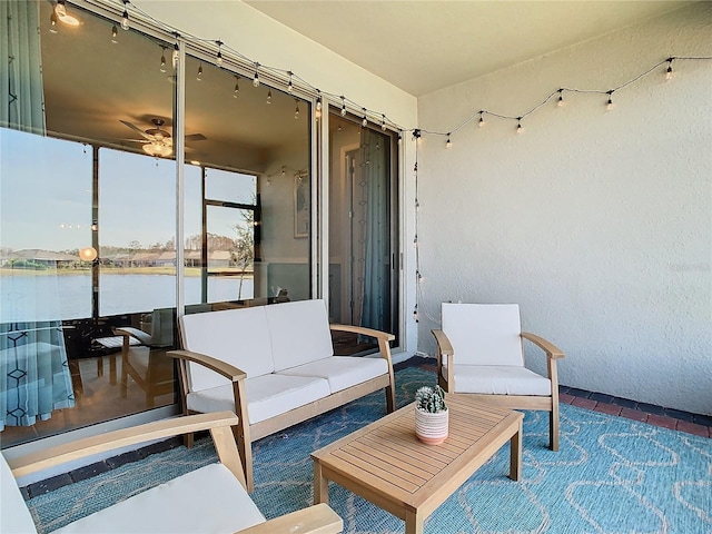 view of patio with an outdoor living space and a water view