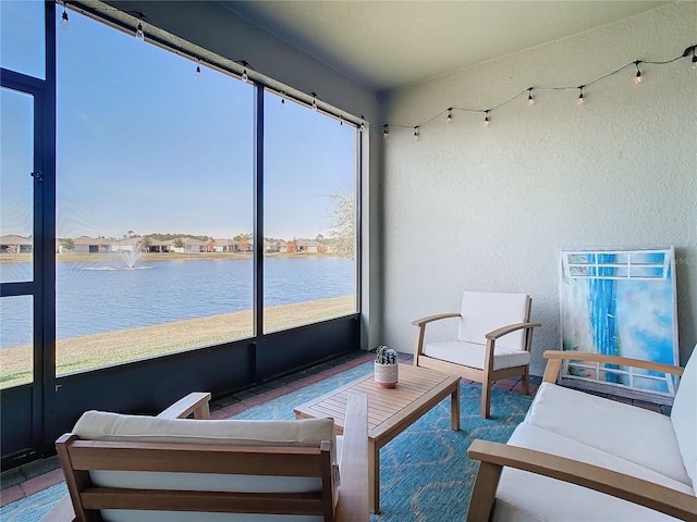 sunroom with a water view and plenty of natural light